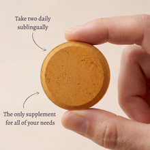 Woman taking an AYA BIOME PURE fermented turmeric chewable tablet